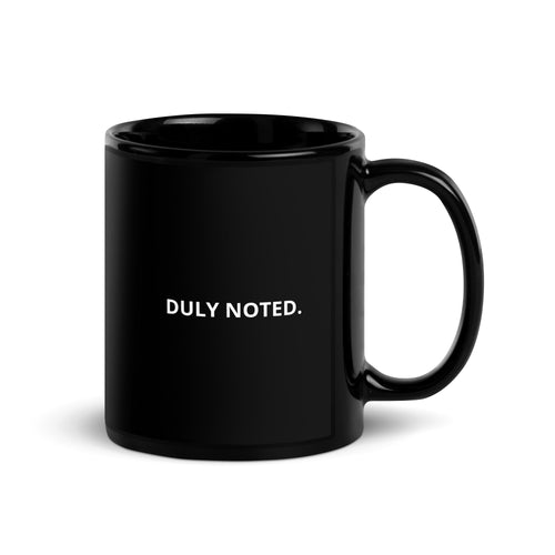 Black ceramic mug with white "Duly Noted." lettering